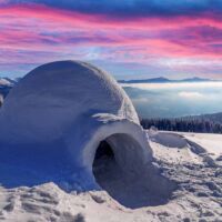 Vista panorámica de un lugar con nieve y en primer plano un iglú