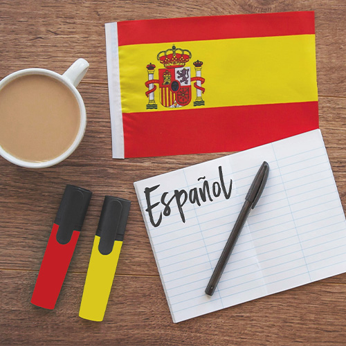 Bandera de España, café y plumones