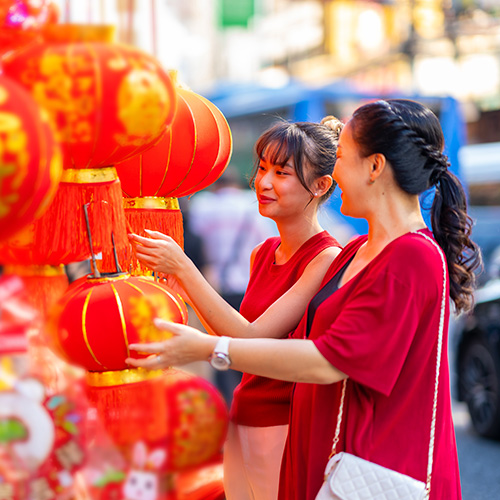 Mamá e hija viendo lámparas chinas rojas